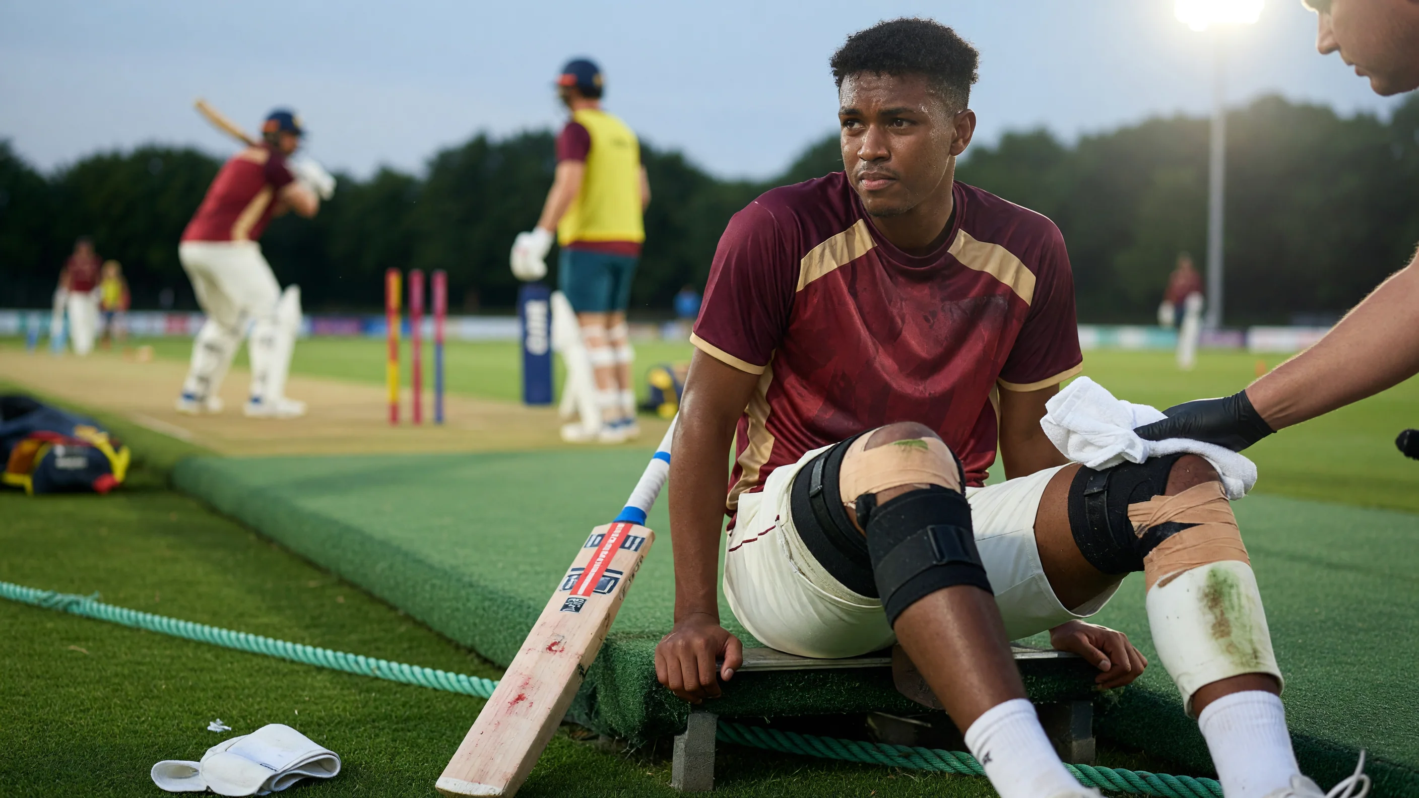 Cricket batter in sideline match action during a floodlit T20 contest